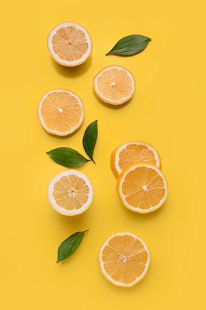 Composition with fresh lemons on yellow backgroundの写真素材
