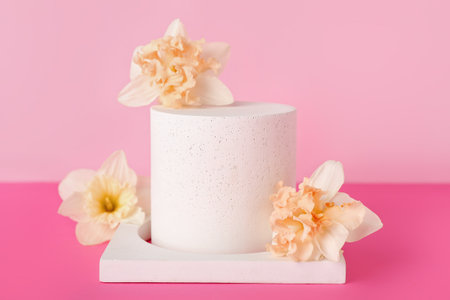 Decorative plaster podiums with flowers on pink backgroundの写真素材
