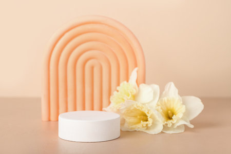 Decorative plaster podiums with flowers on beige backgroundの写真素材