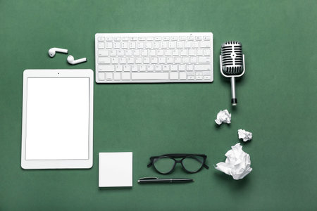 Frame made of journalist's equipment on green background