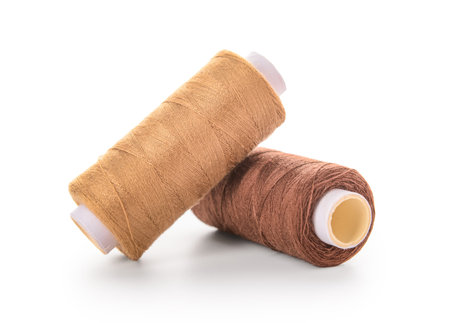 Two thread spools isolated on white background