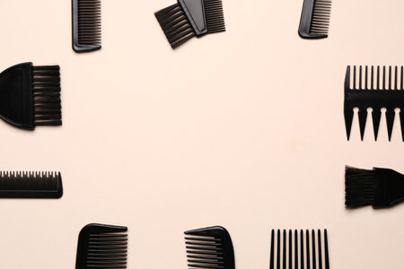 Frame made of hairdresser's brushes on beige backgroundの写真素材