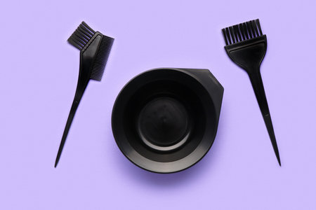 Hairdresser's brushes with bowl on purple backgroundの写真素材