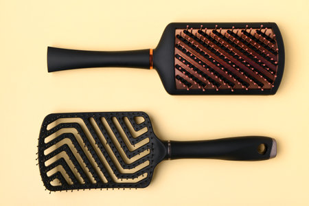Hairdresser's brushes on yellow backgroundの写真素材