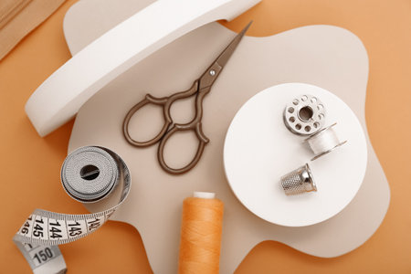 Podiums with tailor's supplies on orange background, closeupの写真素材