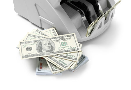 Modern cash counting machine with stack of dollar banknotes on white background, closeupの写真素材
