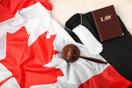 Judge's gavel with gown, law book and flag of Canada on white background, closeupの写真素材