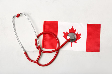 Flag of Canada with stethoscope on white backgroundの写真素材