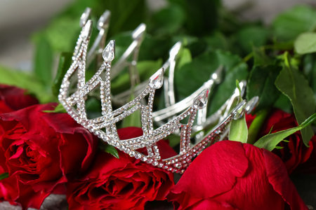 Beautiful crown on red roses, closeup. Prom concept