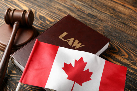 Flag of Canada with law book and judge's gavel on wooden background, closeupの写真素材