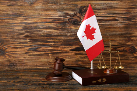 Flag of Canada, judge's gavel, justice scales and law book on wooden backgroundの写真素材