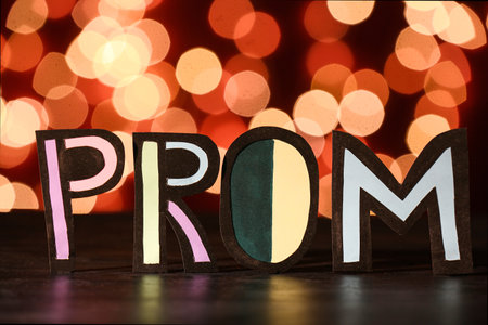 Word PROM on dark table against blurred lightsの写真素材