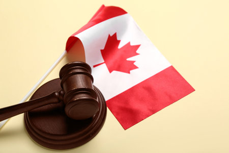 Flag of Canada with judge's gavel on beige background, closeupの写真素材