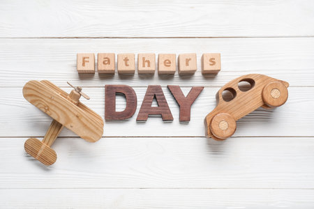 Text FATHER'S DAY with toys on white wooden backgroundの写真素材