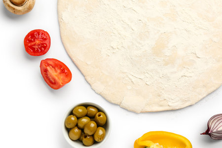Raw dough and ingredients for preparing vegetable pie on white backgroundの写真素材