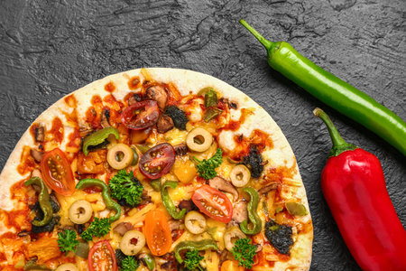Vegetable pizza with ingredients on dark backgroundの写真素材