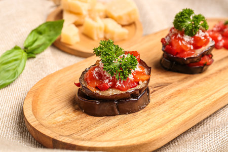 Plate with tasty baked Eggplant Parmesan on table, closeupの写真素材