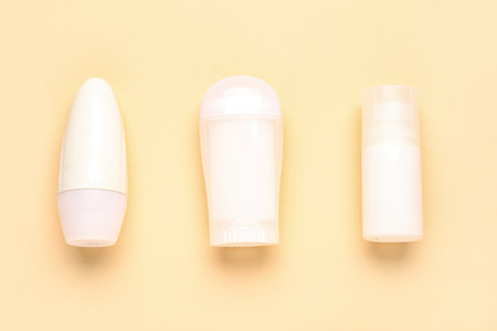 Different deodorant bottles on yellow backgroundの写真素材