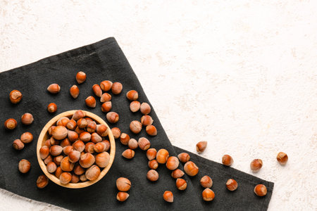 Bowl with shelled hazelnuts on table