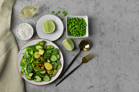 Plate of salad with green vegetables and ingredients on gray grunge backgroundの写真素材