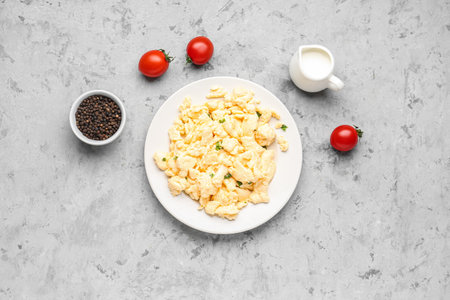 Plate of scrambled eggs with peppercorns on grunge backgroundの写真素材