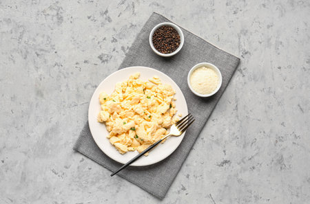 Composition with plate of scrambled eggs on grunge backgroundの写真素材