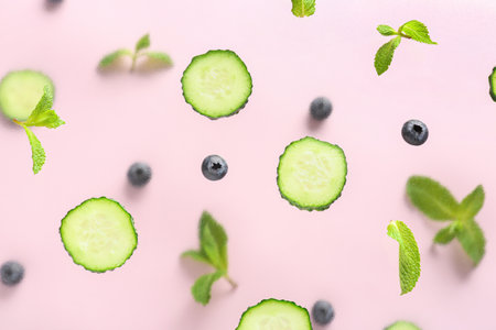Slices of cucumber with blueberry and mint on lilac backgroundの写真素材