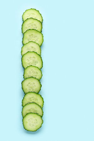 Slices of cucumber on turquoise backgroundの写真素材