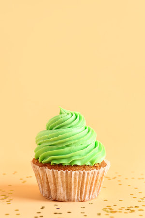 Tasty cupcake on orange backgroundの写真素材