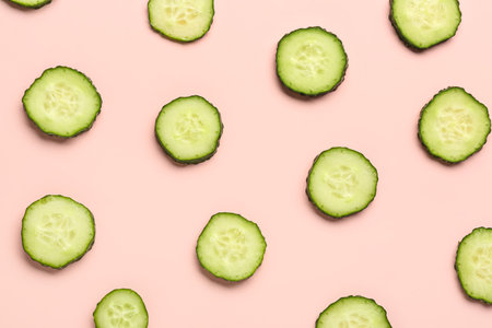 Slices of cucumber on pink backgroundの写真素材