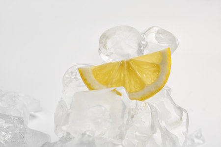 Sliced fresh lemon and ice isolated on white backgroundの写真素材