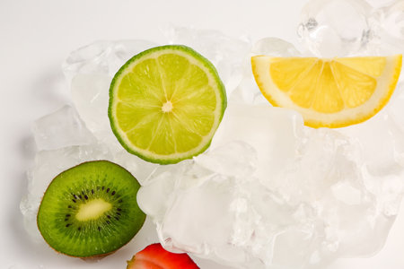 Sliced fresh fruits and ice isolated on white backgroundの写真素材