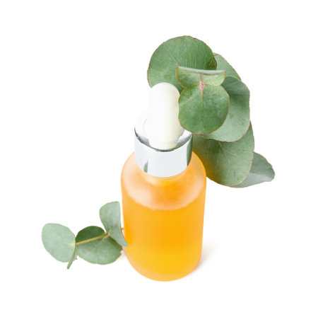 Bottle with cosmetic oil and eucalyptus branch on white backgroundの写真素材