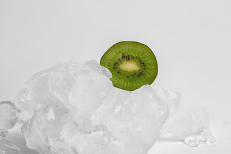 Sliced fresh kiwi and ice isolated on white backgroundの写真素材