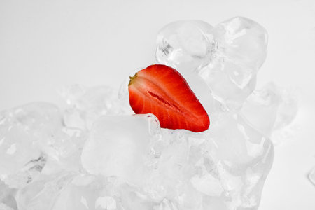 Sliced fresh strawberry and ice isolated on white backgroundの写真素材