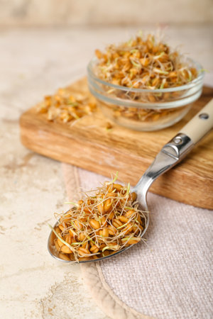 Bowl and spoon with sprouted wheat on grunge tableの写真素材
