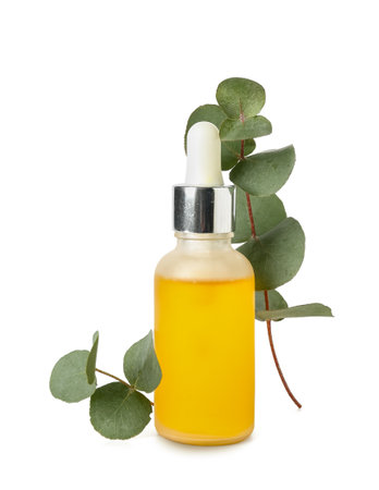 Bottle with cosmetic oil and eucalyptus branch on white backgroundの写真素材