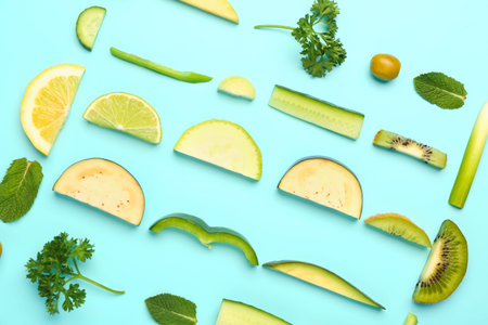 Composition with fresh fruits and vegetables on turquoise background