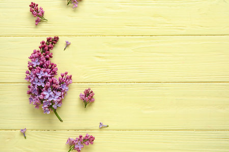 Blooming lilac flowers on beige wooden backgroundの写真素材