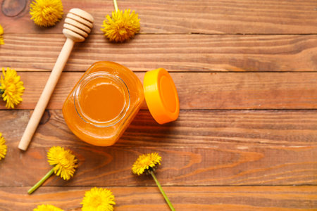Jar with dandelion honey on wooden backgroundの写真素材