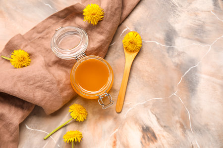 Jar with dandelion honey on marble backgroundの写真素材