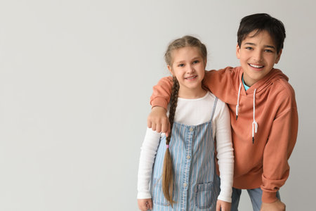 Little children hugging on light backgroundの写真素材