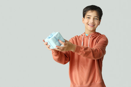 Little boy with gift on light background. Children's Day celebrationの写真素材