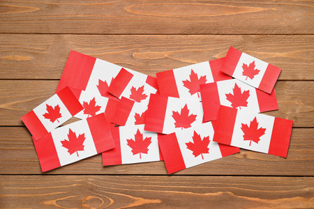 Paper flags of Canada on wooden backgroundの写真素材