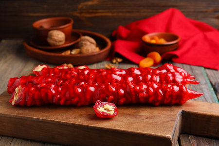 Board with tasty churchkhela on wooden backgroundの写真素材