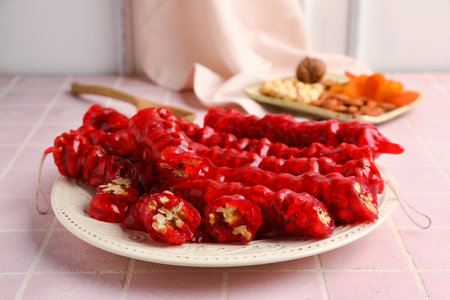 Plate with tasty churchkhela on tableの写真素材