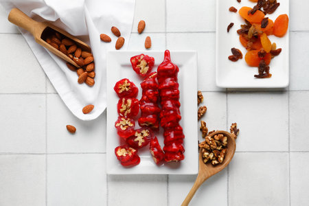 Plate with tasty churchkhela on light tile backgroundの写真素材