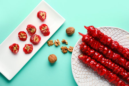 Plates of tasty churchkhela on turquoise backgroundの写真素材