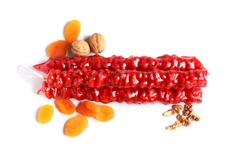 Tasty churchkhela with nuts and dried apricots on white backgroundの写真素材