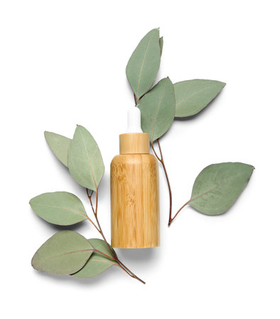 Bottle of cosmetic oil with plant twig on white backgroundの写真素材